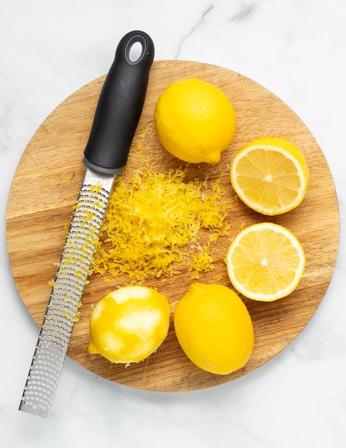lemons and microplane on a wooden board