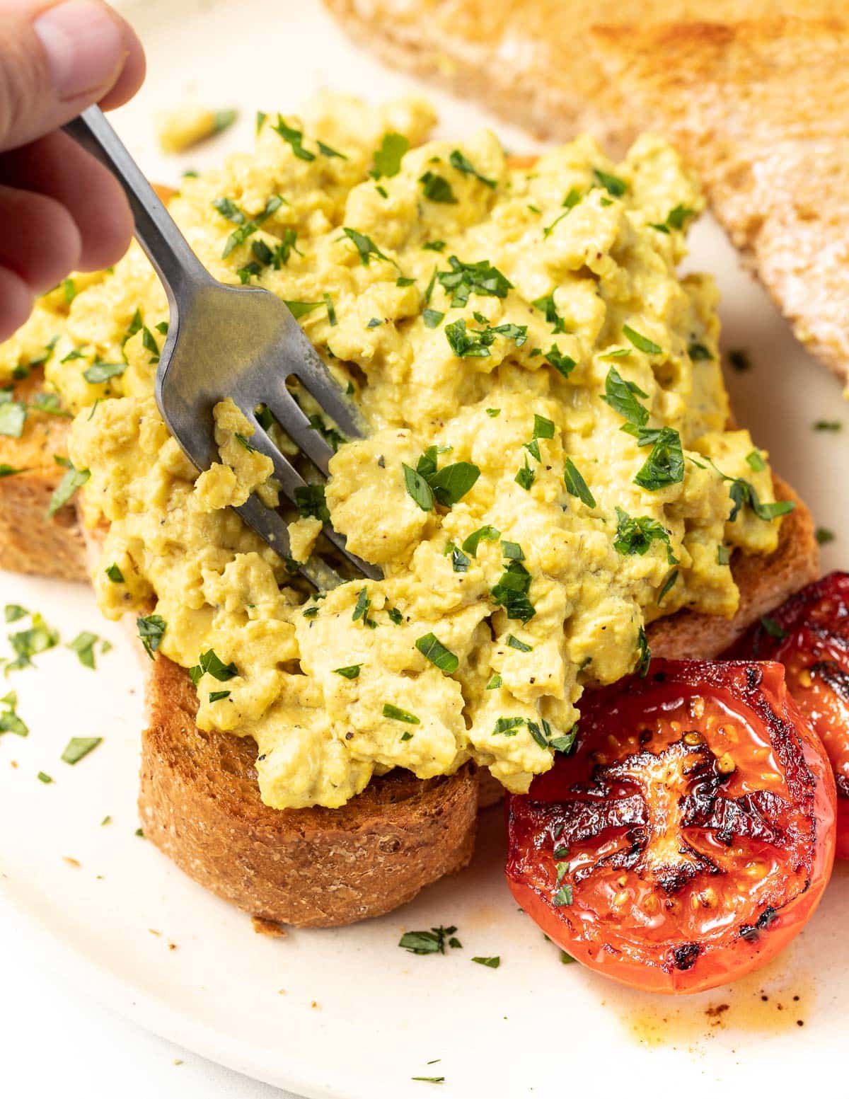 a fork digging into vegan scrambled eggs