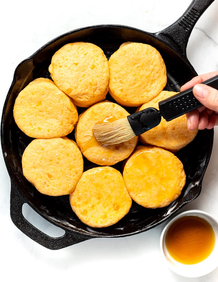 brushing biscuits with maple syrup