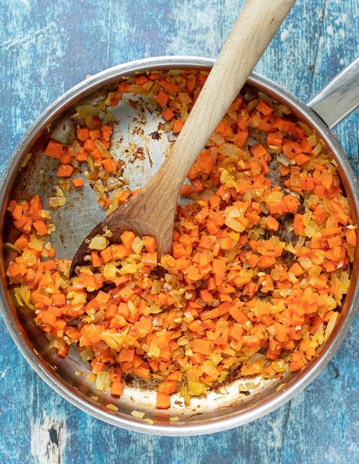 diced onions, garlic and carrot cooking in a pan