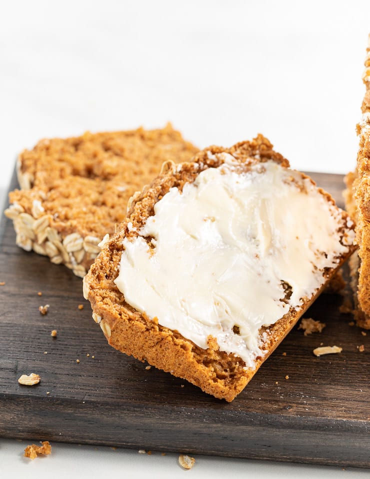 a close up shot of a slice of buttered spelt bread 