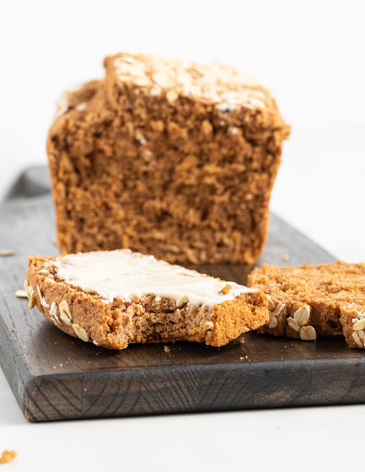 a slice of spelt bread with a bite taken out showing inside texture