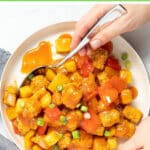 Healthier Sweet and Sour Tofu with crispy, crunchy, chewy baked tofu, sweet, savory, fruity, tangy sauce and chunks of bell pepper, onion and pineapple. Just perfect served over fluffy rice!