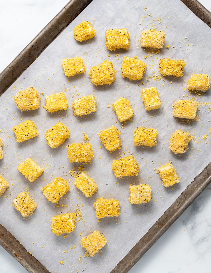 cornmeal coated tofu on a baking tray