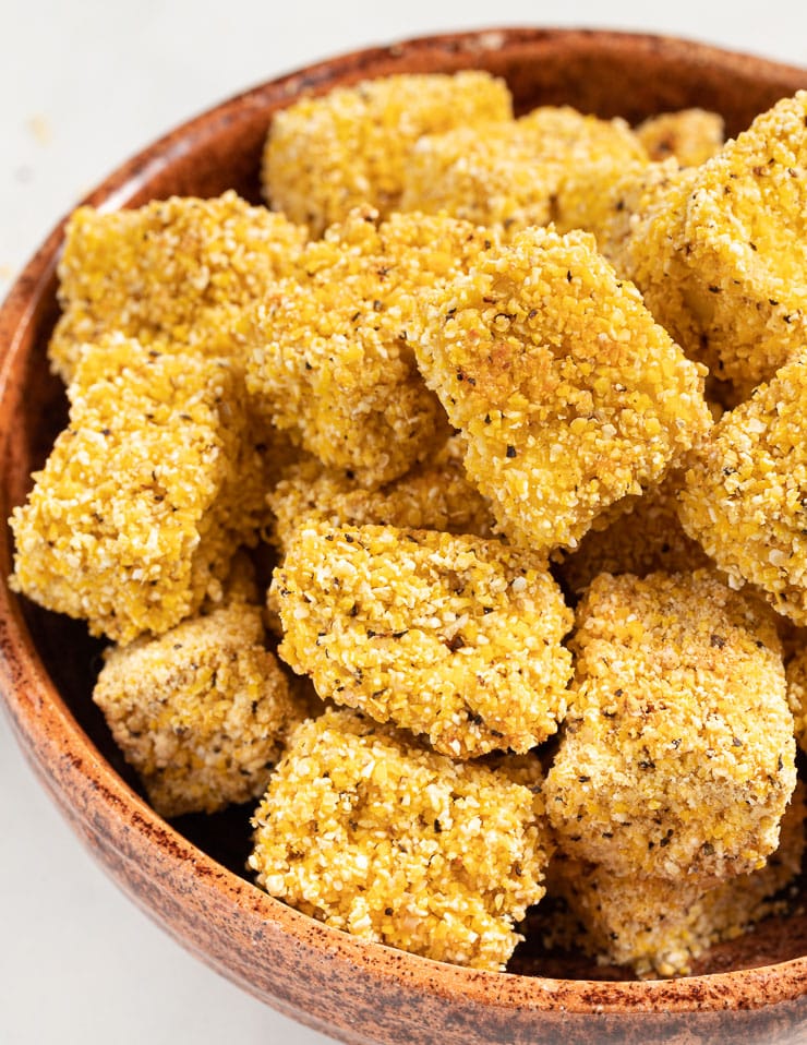 a brown bowl full of crispy tofu pieces