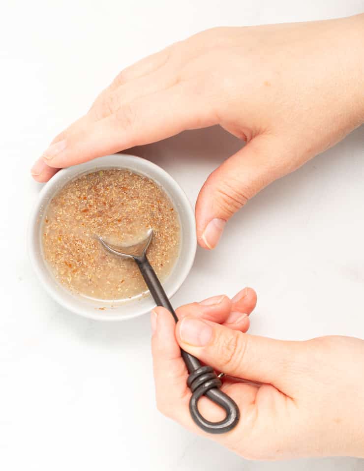 ground flax and water being mixed together in a small bowl to make a flax egg