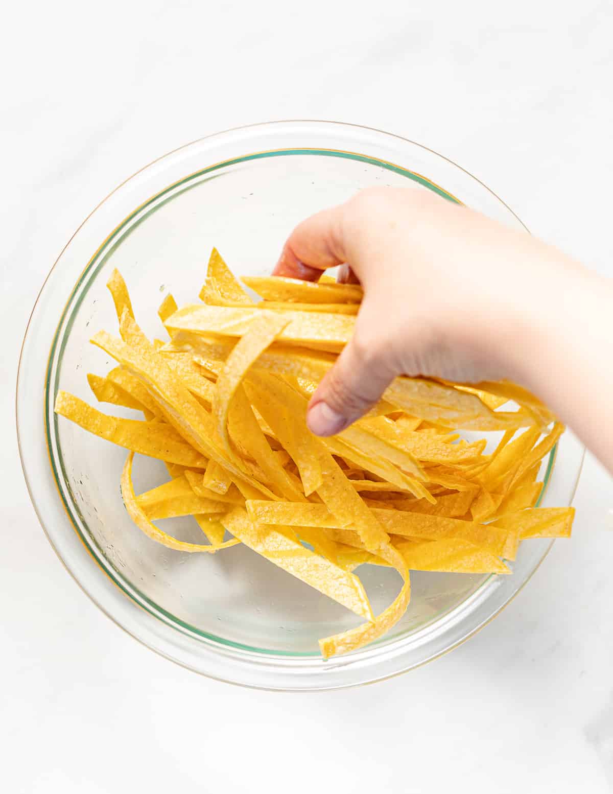 massaging oil into tortilla strips