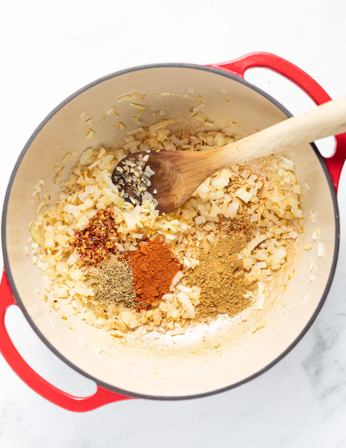 spices, onion and garlic cooking in a pan