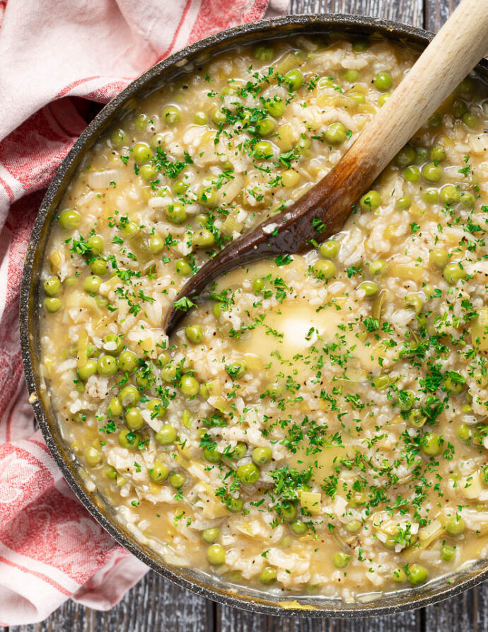 a close up of Risi e Bisi in a pan (Italian Rice and Peas)
