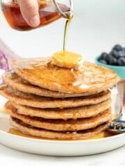 a stack of spelt pancakes with butter and syrup