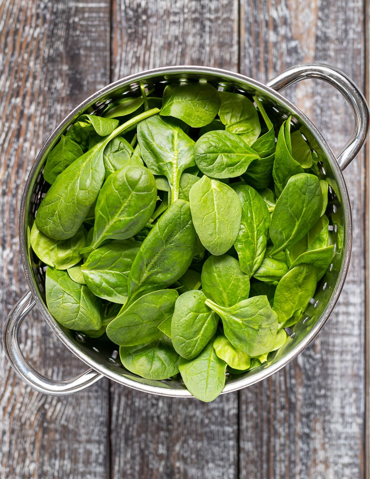 baby spinach in a colander