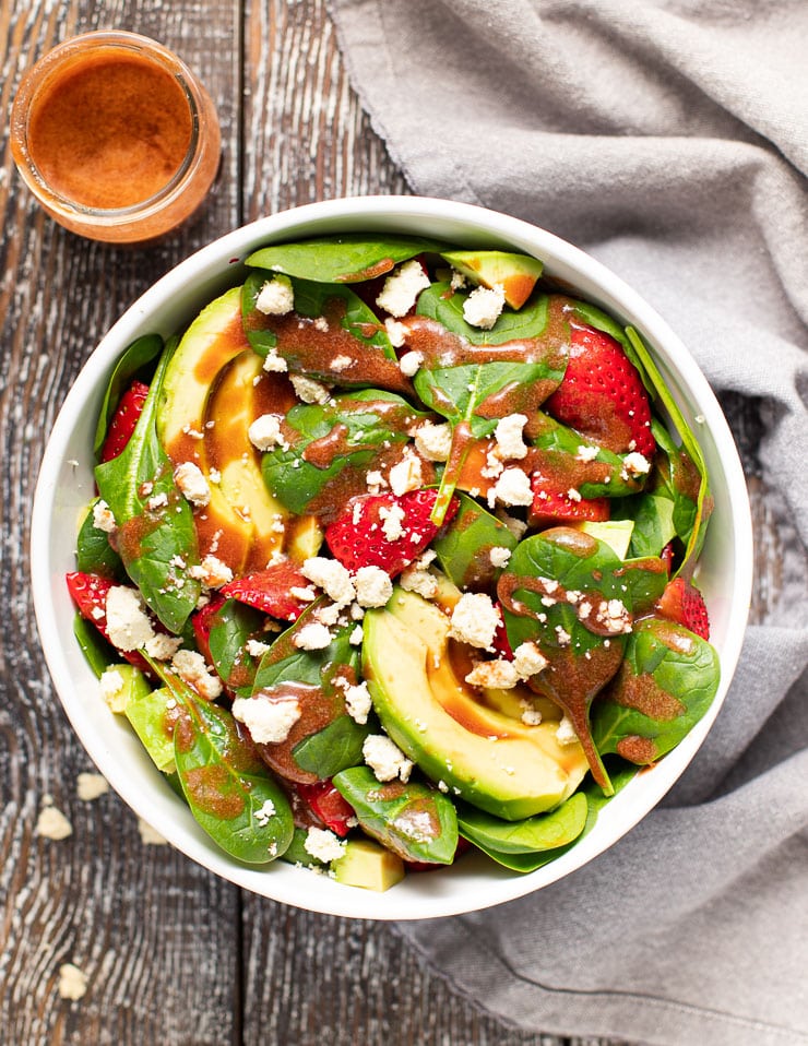 a large bowl of strawberry spinach salad