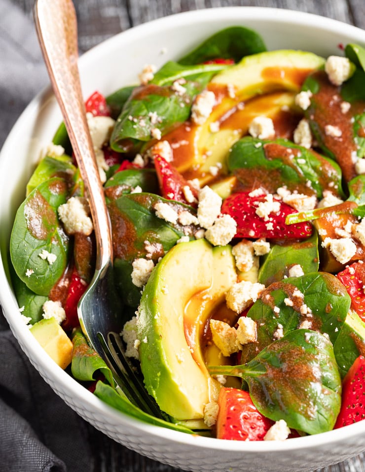 close up of dressed strawberry avocado salad 