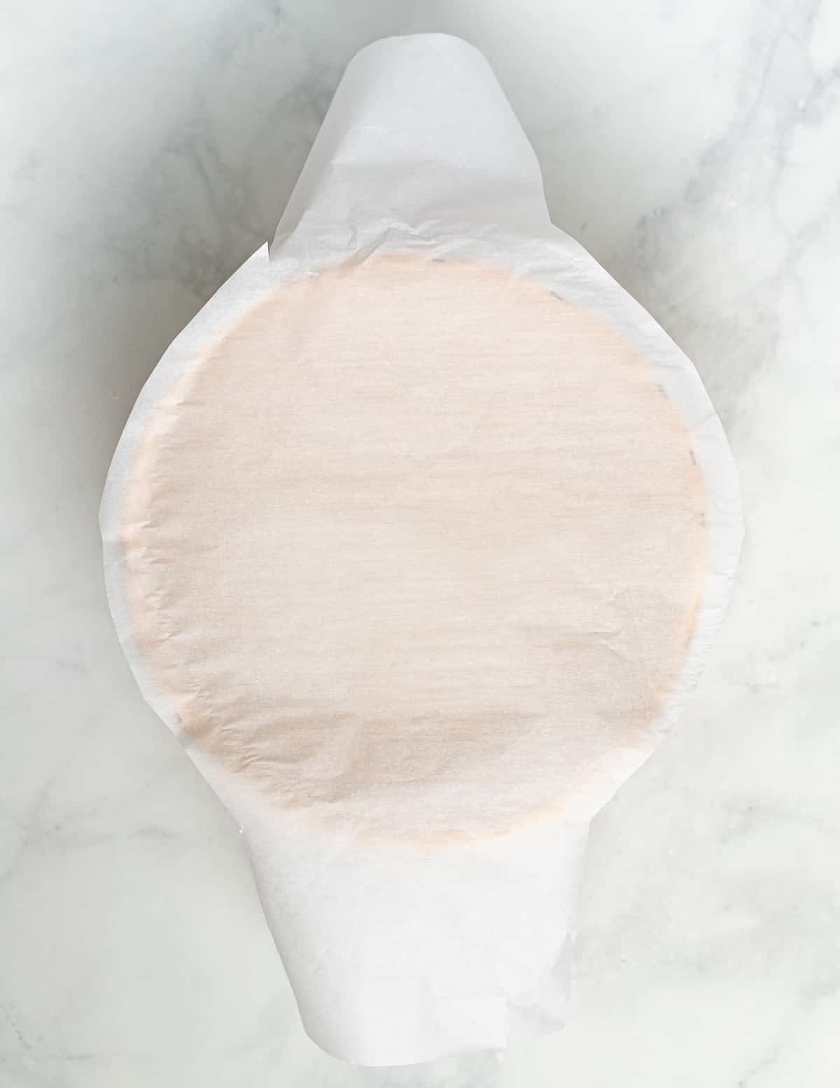 a piece of parchment paper cut so it has handles to lift bread in and out of Dutch oven