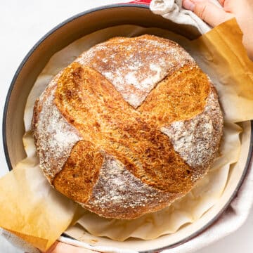 crusty sourdough bread in a Dutch oven
