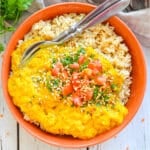 a bowl of red lentil dal with rice