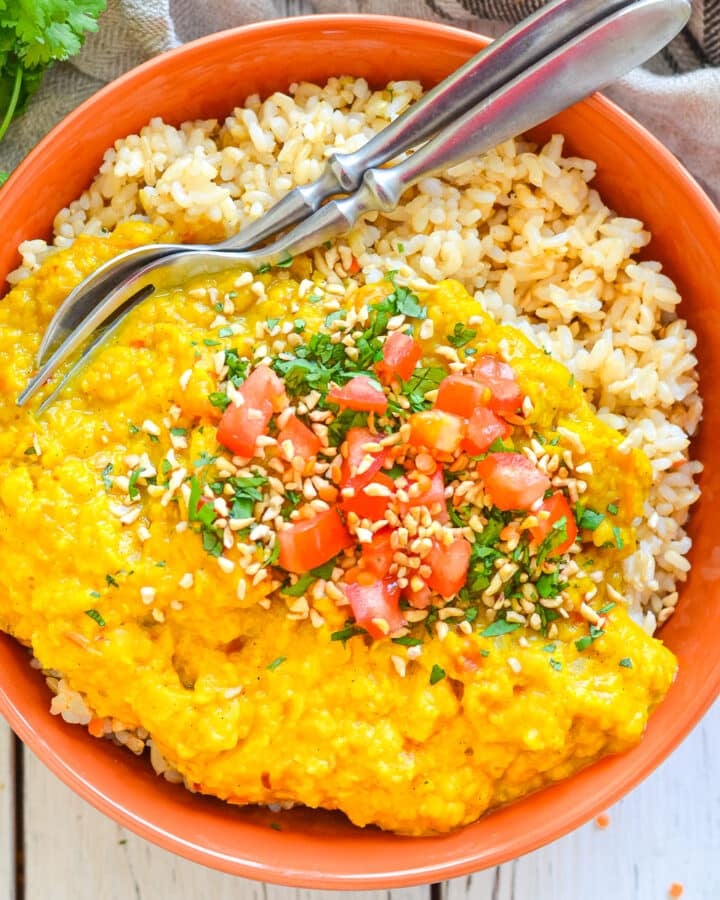 a bowl of red lentil dal with rice