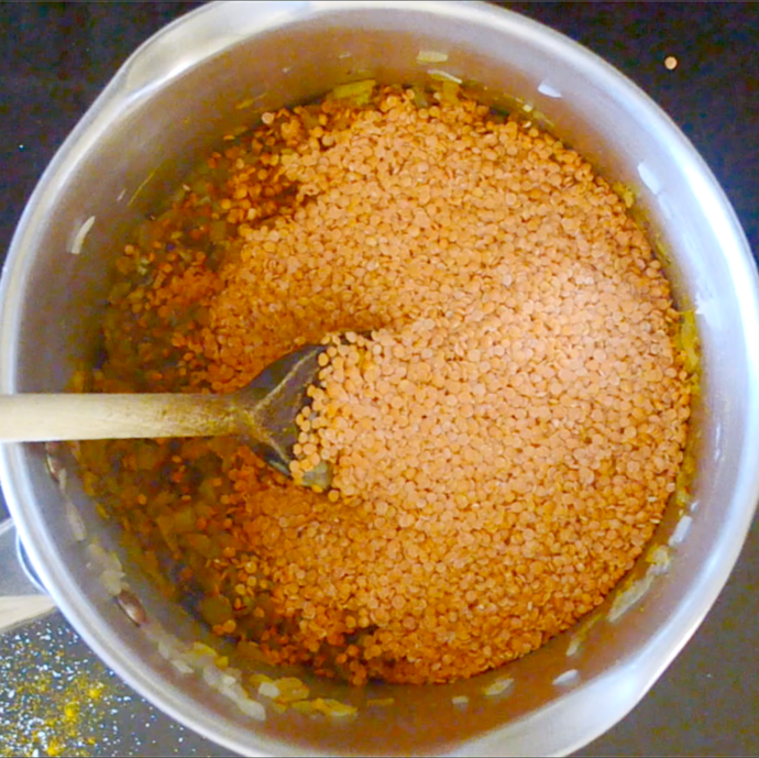 red lentils in a pan with onion and spices