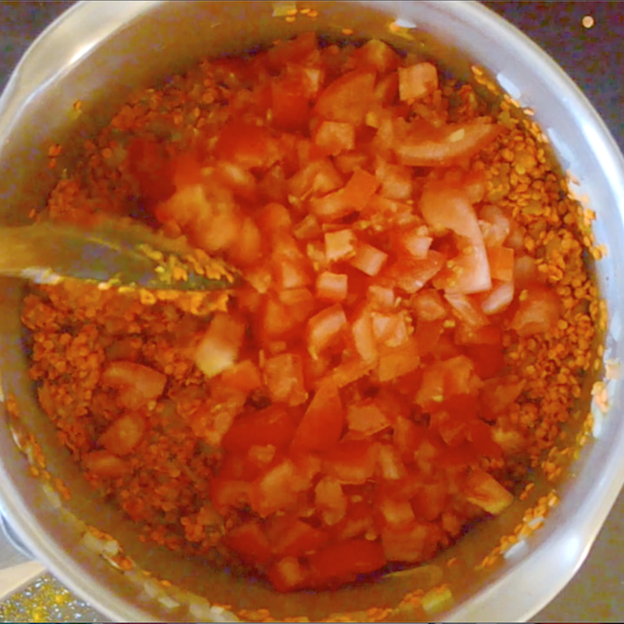 tomatoes and red lentils in a pan