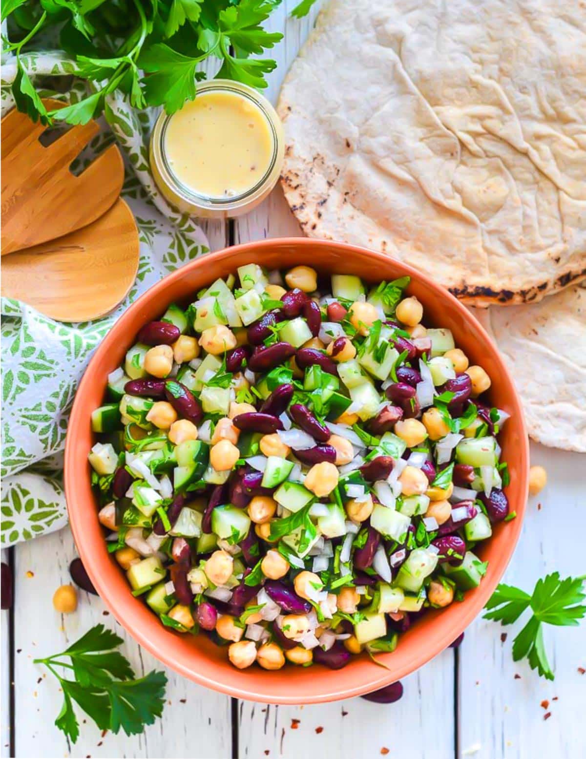 Overhead view of a colorful Kidney Bean Salad in orange serving bowl 
