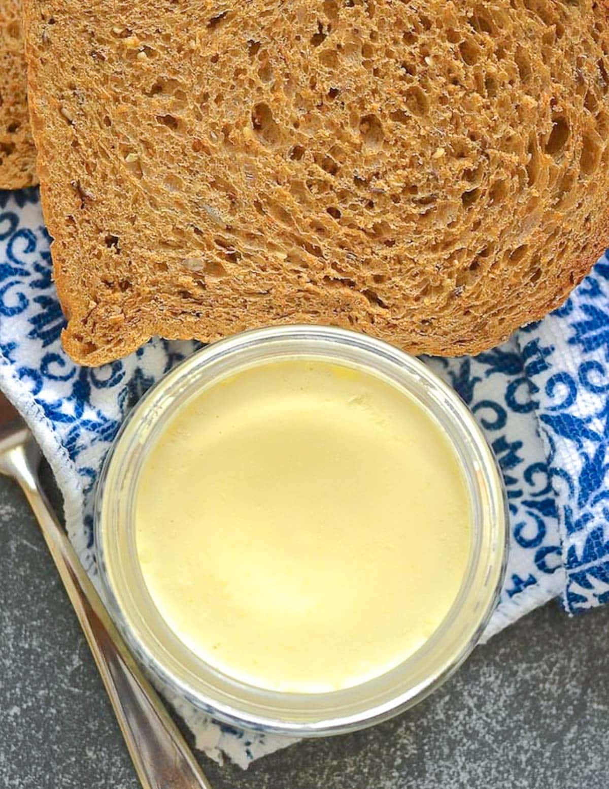 a small jar of vegan butter and a slice of wholewheat bread 