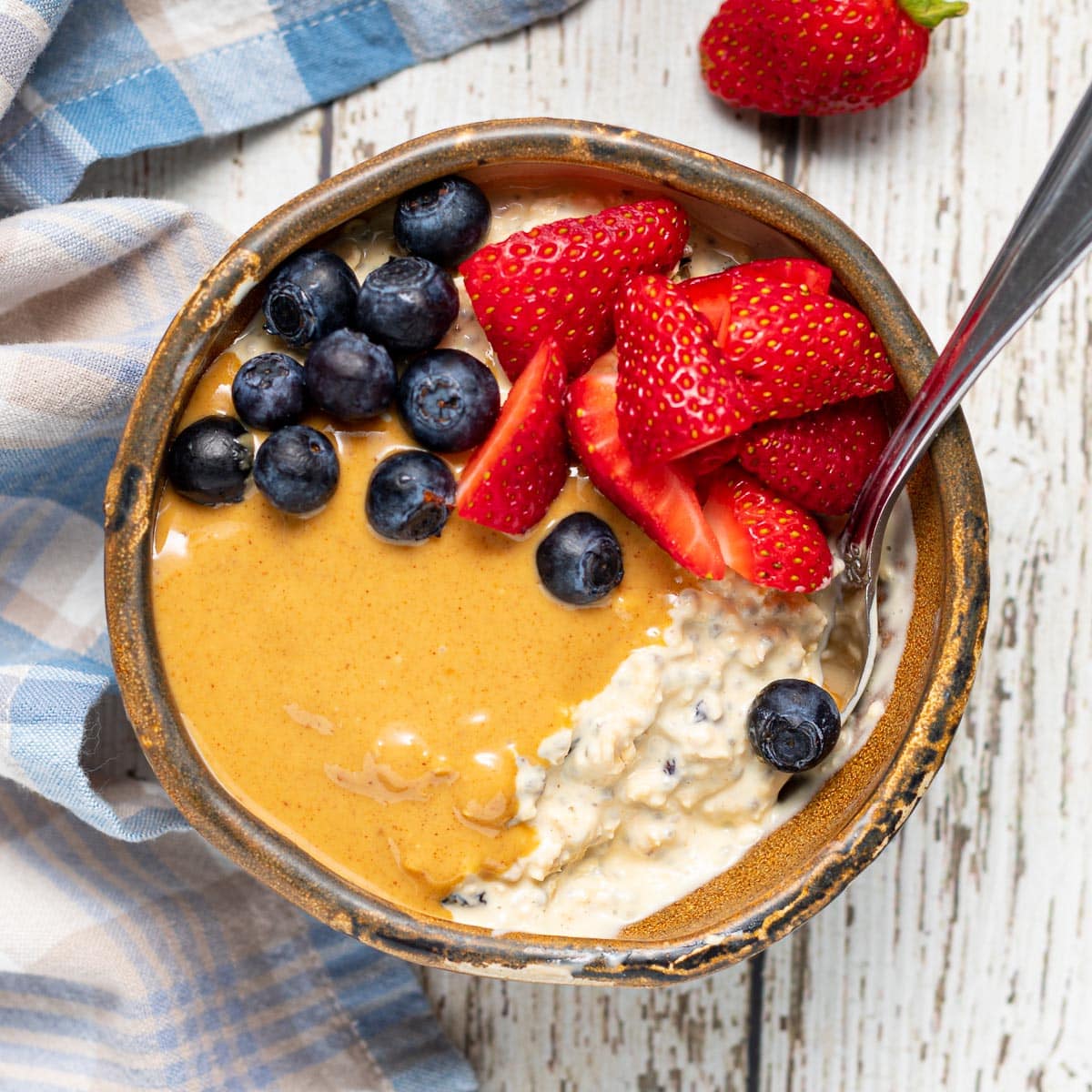 a bowl of Bircher Muesli with nut butter and fruit