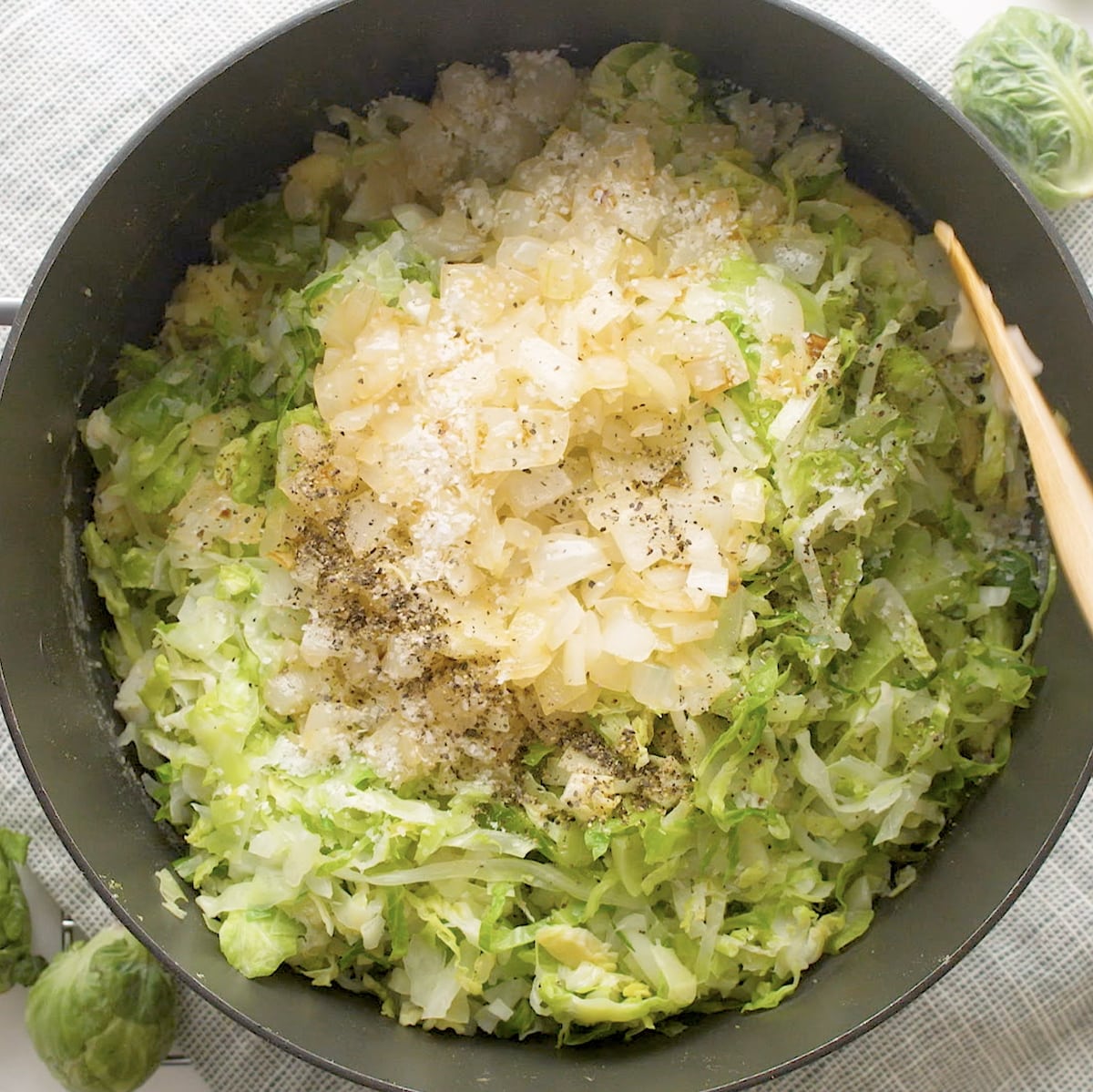 mashe dpotatoes, cabbage, sprouts and onion in a pan