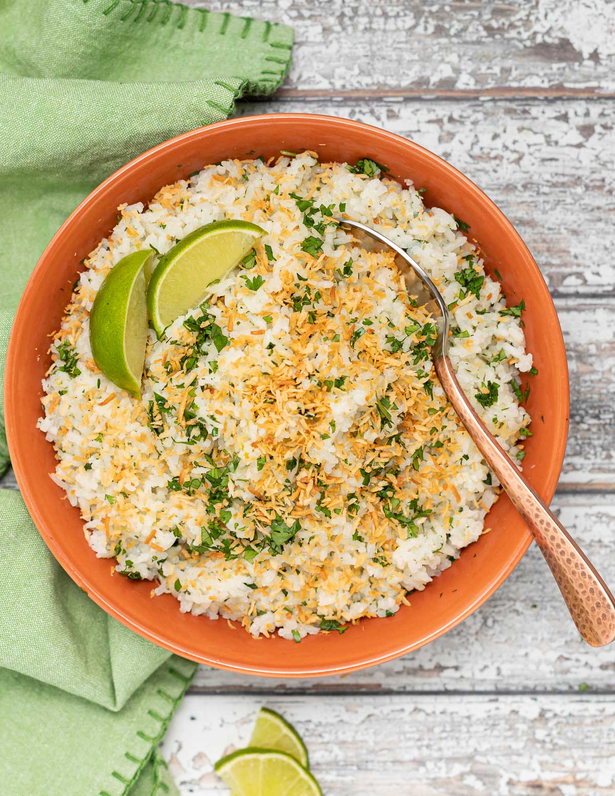 coconut lime rice garnished with lime wedges and toasted coconut 