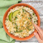 coconut lime rice in a bowl with a spoon