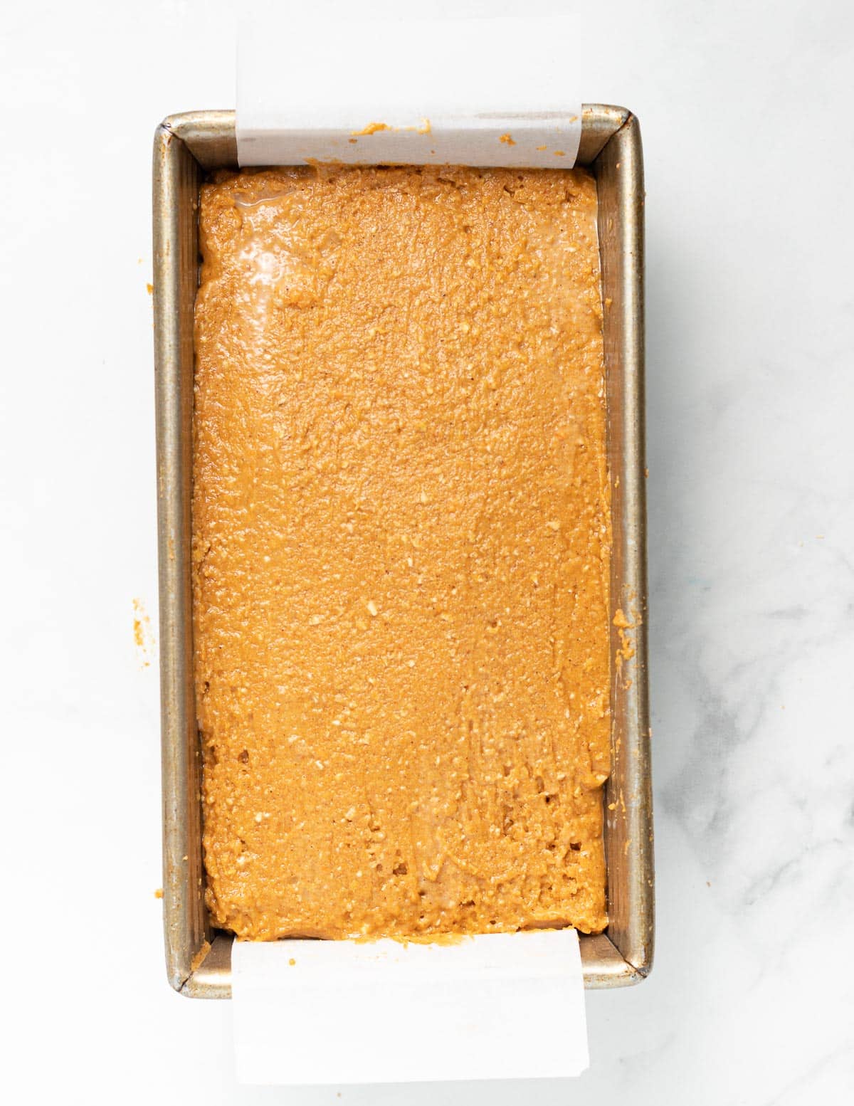 quick bread batter in a lined loaf pan