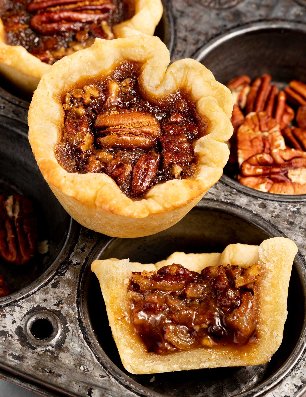 a butter tart and half a butter tart showing the filling