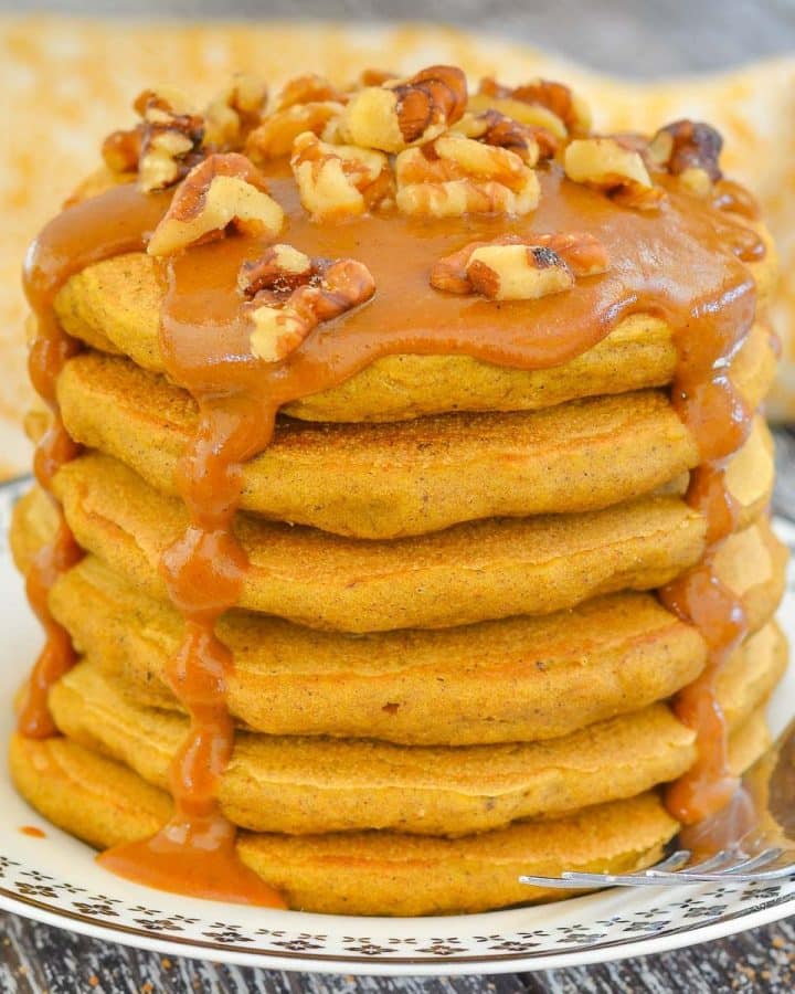 a stack of sweet potato pancakes with caramel and nuts