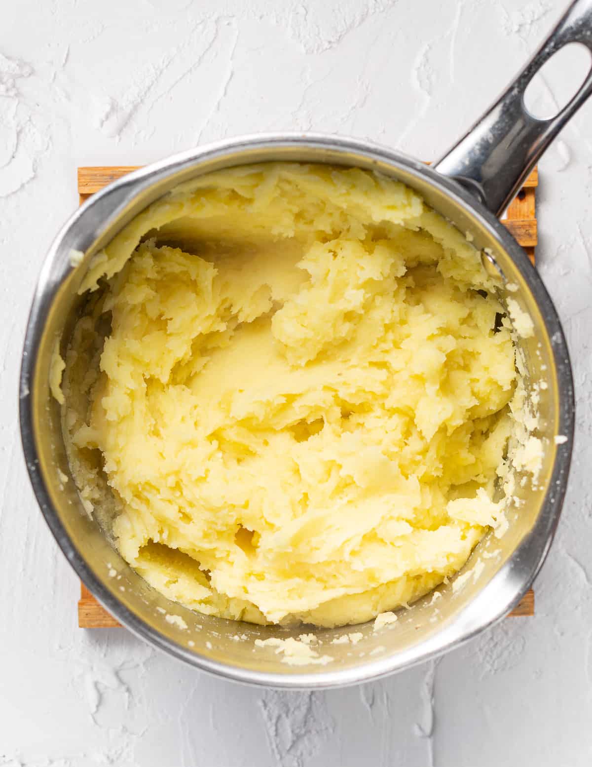 roughly mashed potatoes in a pan