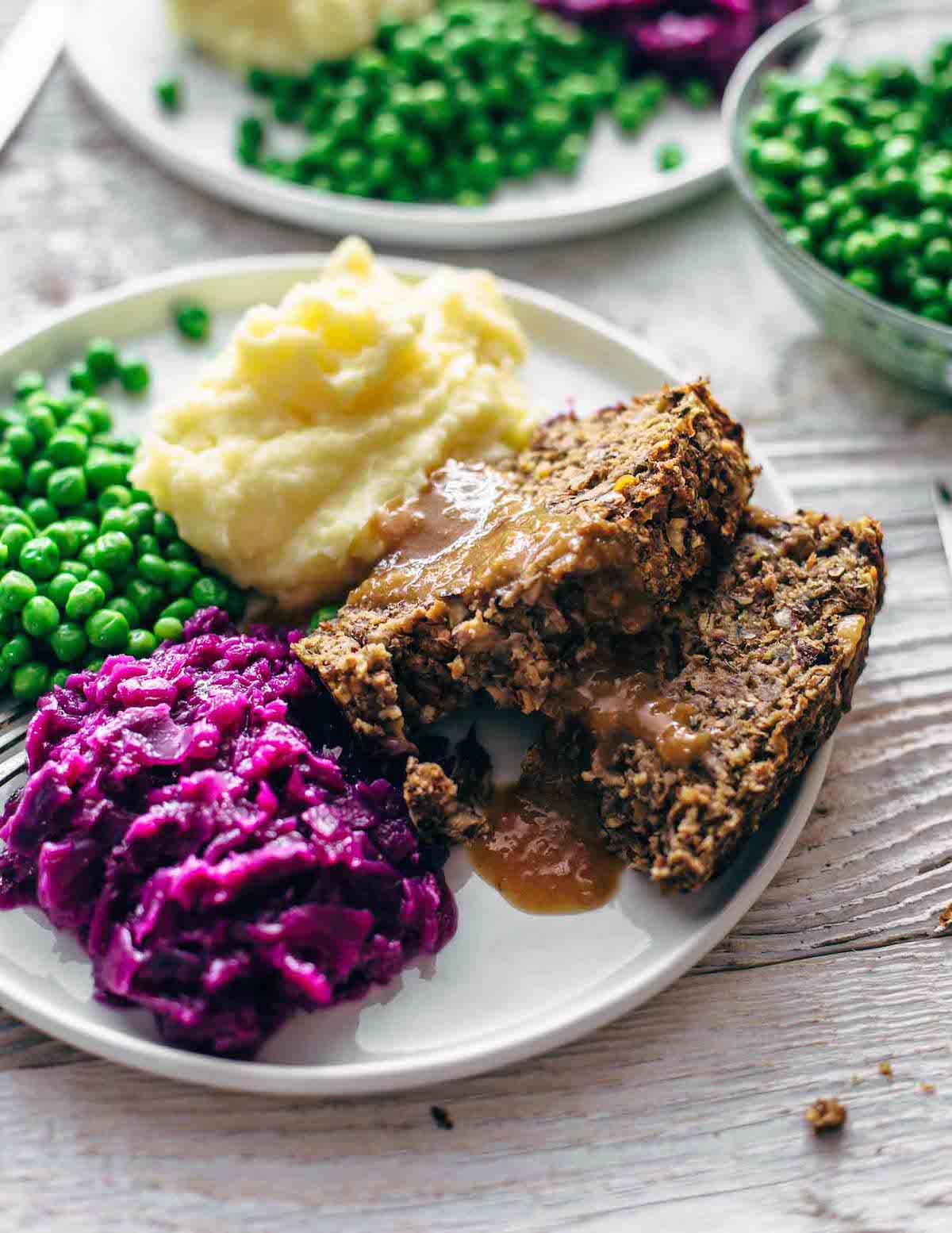 vegan meatloaf with mashed potatoes, gravy and red cabbage