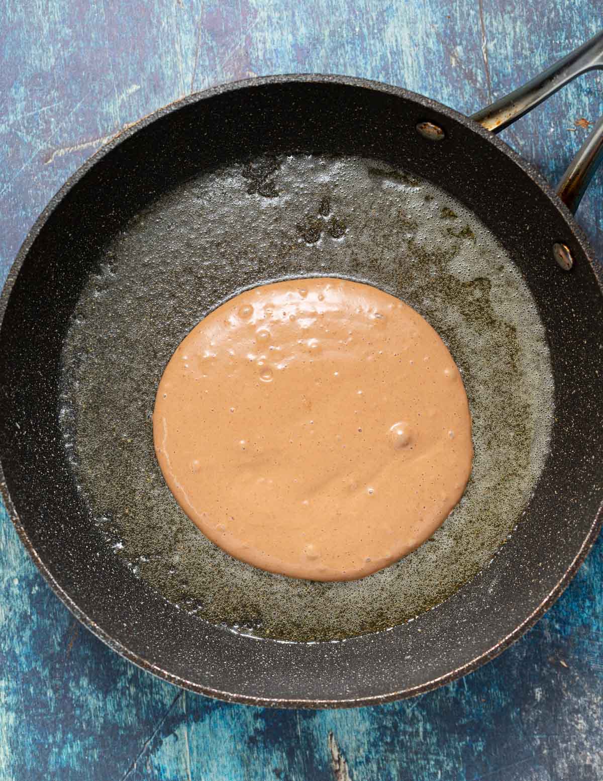 uncooked pancake in a pan