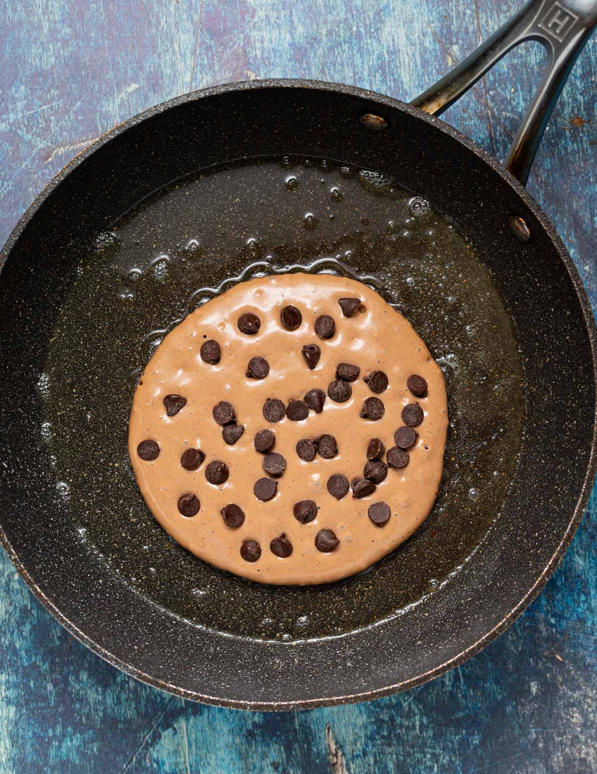 an uncooked pancake with chocolate chips sprinkled on it