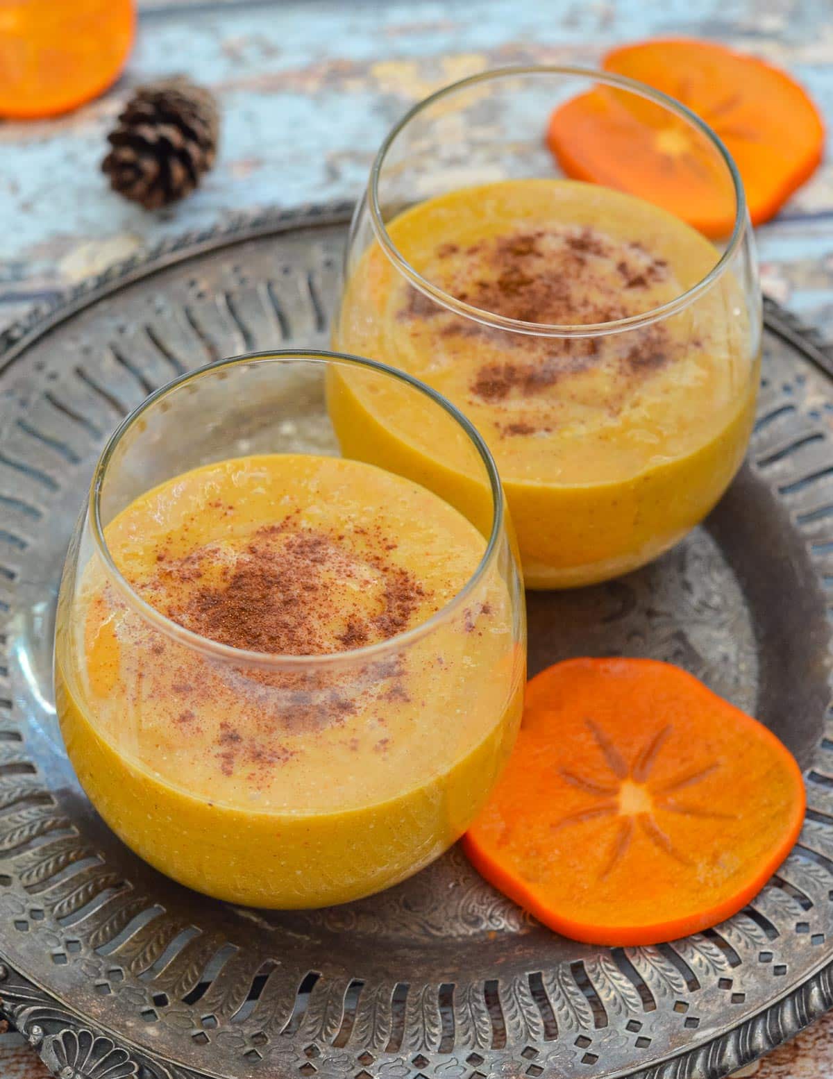 2 glasses of persimmon smoothie on a tray