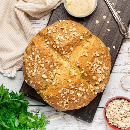 a loaf of vegan soda bread on a wooden board