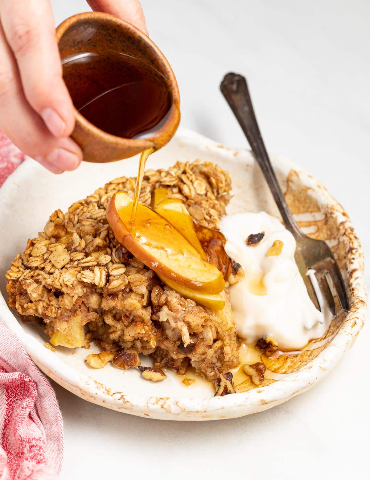 maple syrup pouring over baked oatmeal