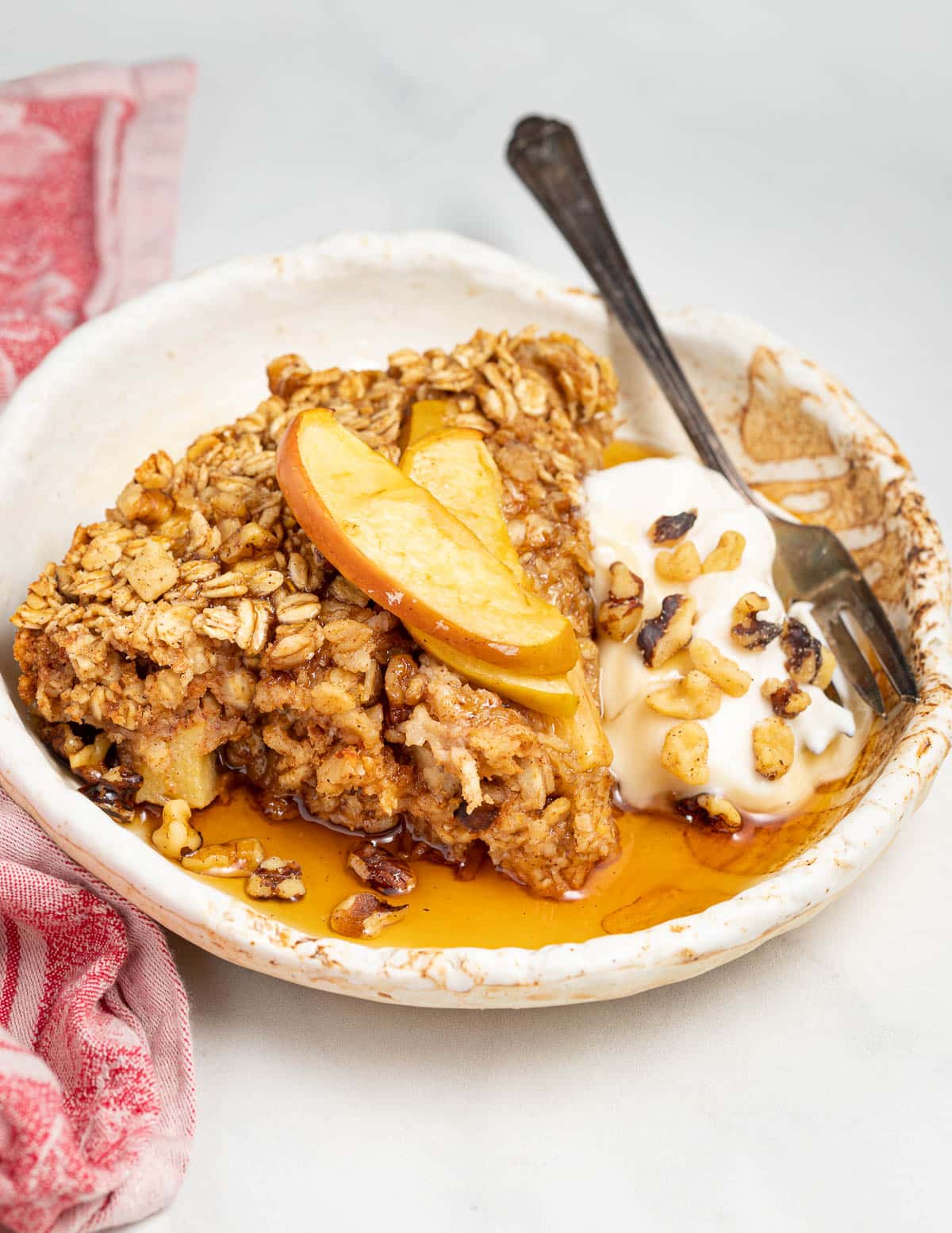 a slice of baked oatmeal with maple syrup