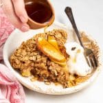 pouring syrup over apple baked oatmeal