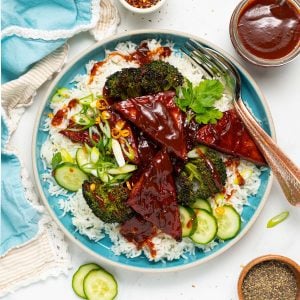 a blue plate with rice, broccoli and BBQ tofu