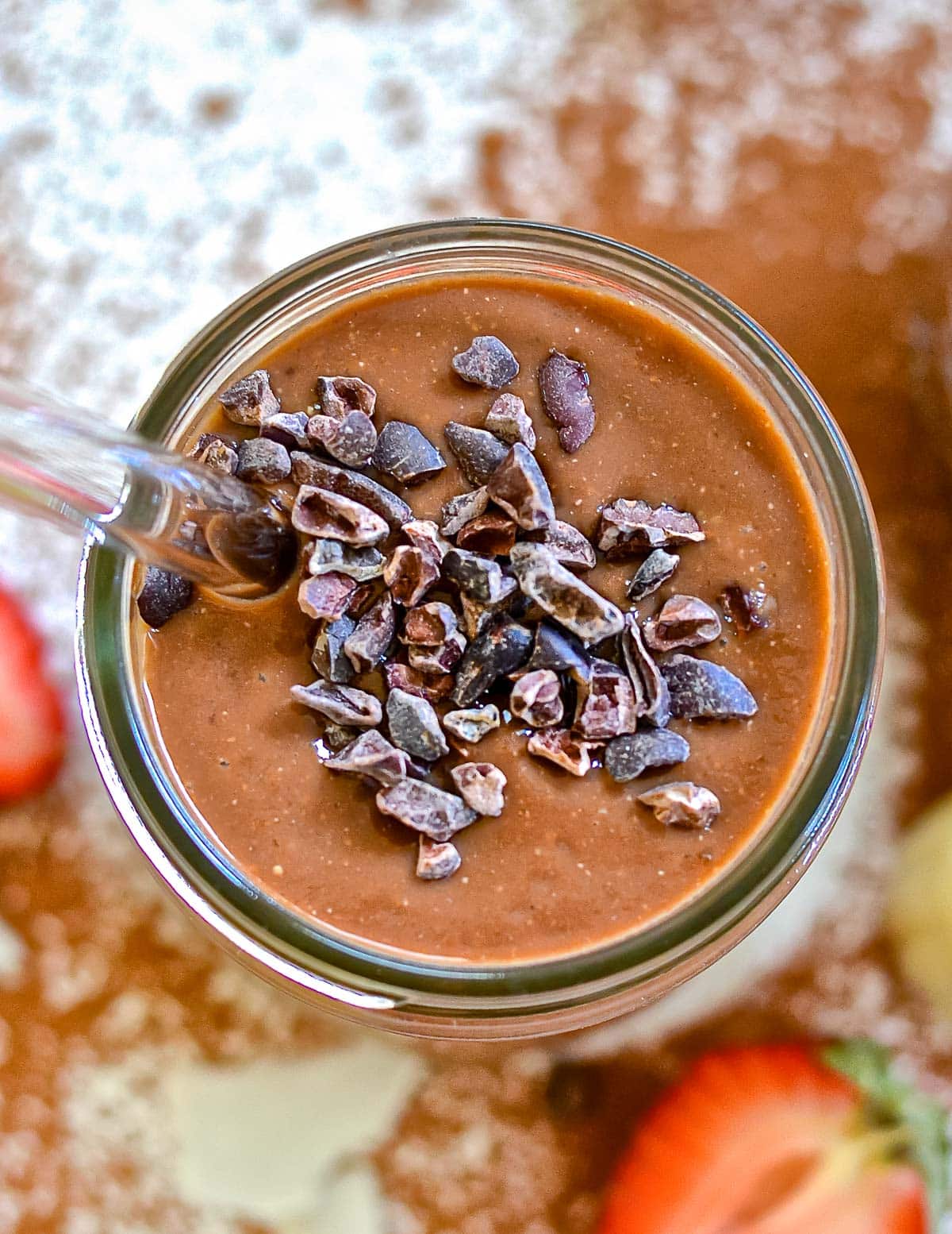 a healthy chocoalte smoothie topped with cacao nibs
