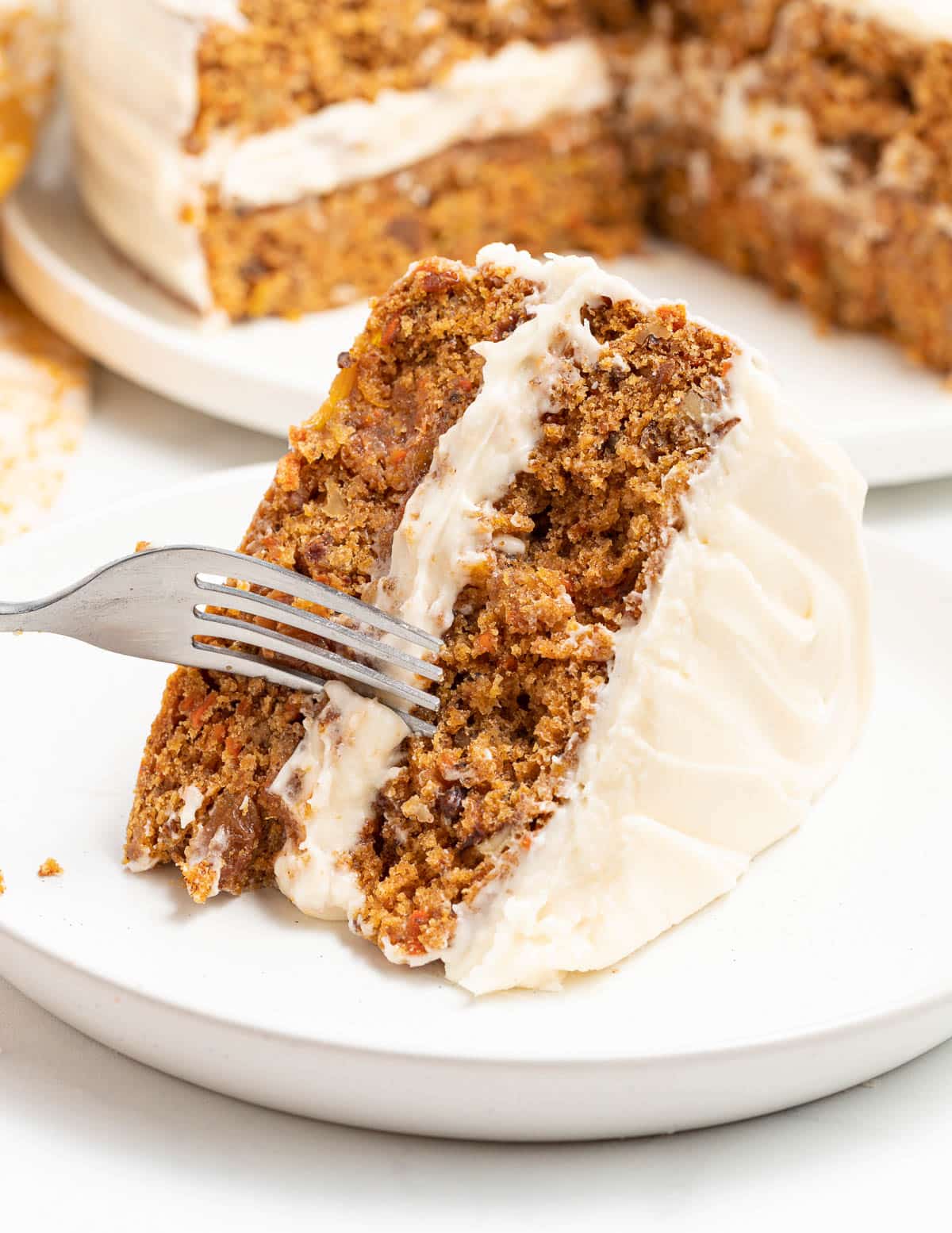 a slice of vegan carrot cake on a plate