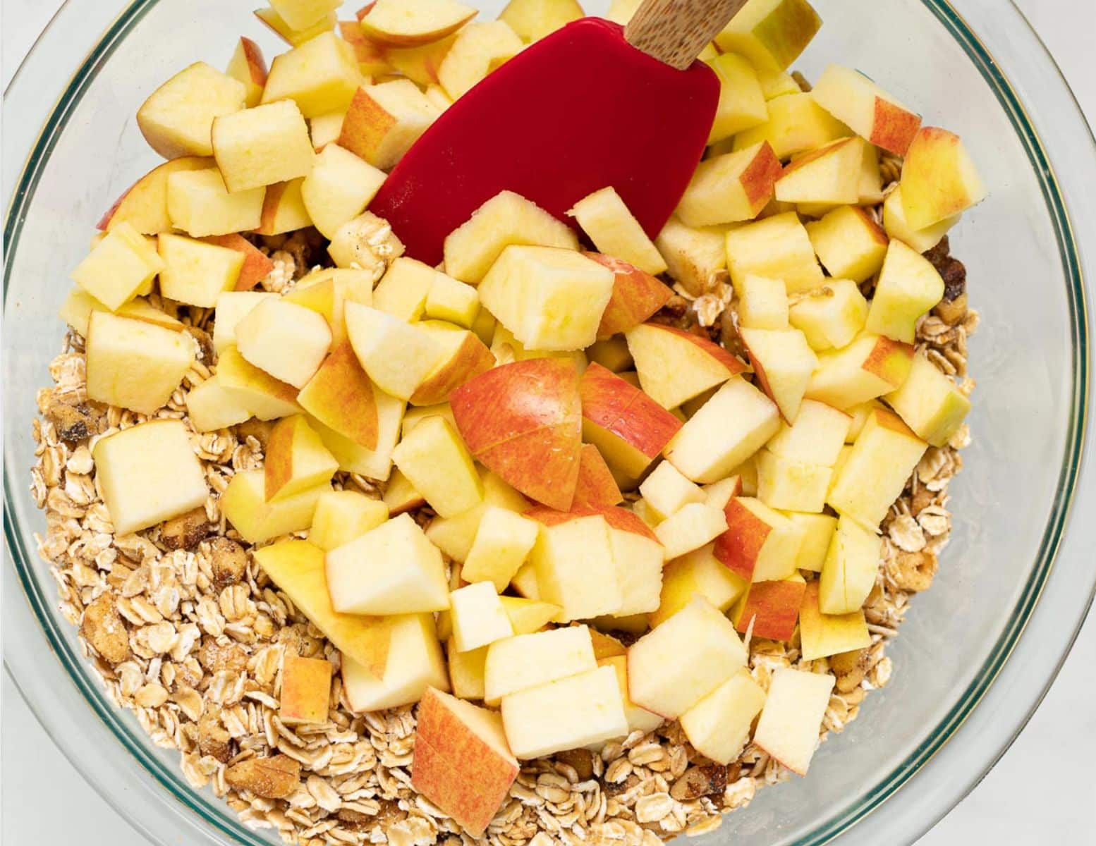 an oaty mixture with chopped apples in a bowl