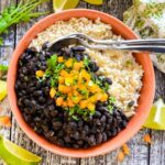 a bowl of sloe cooker black beans over rice