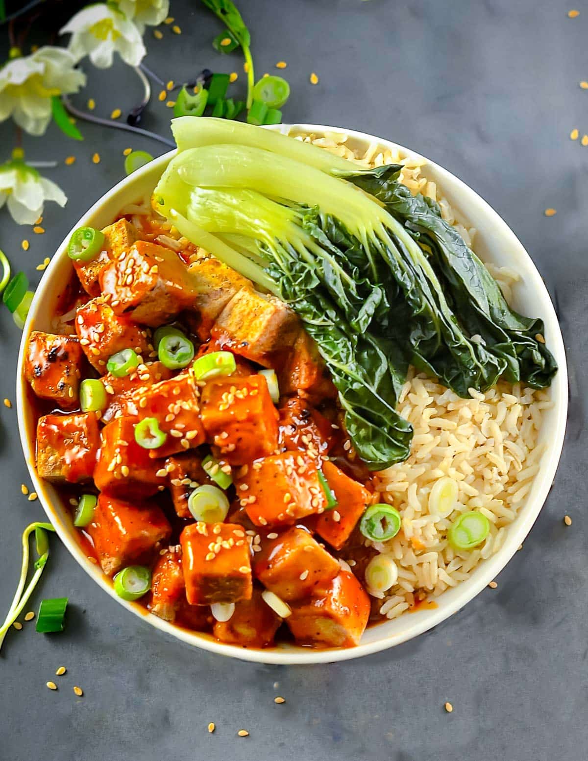 a bowl of tofu, rice and bok choy