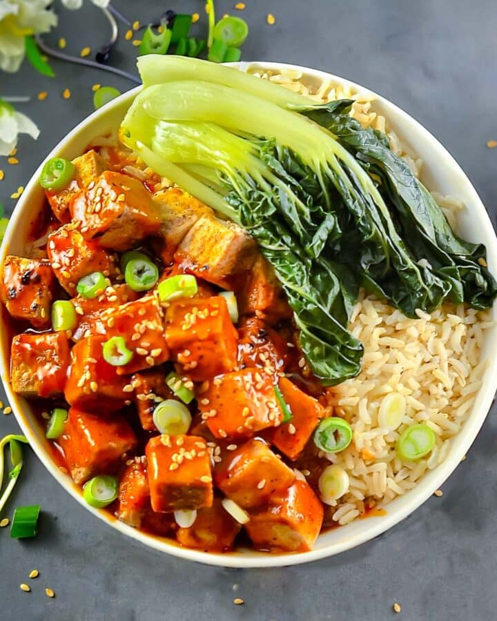 a bowl of tofu, rice and bok choy