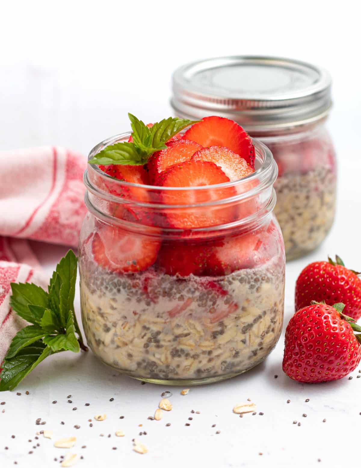a jar of overnight oats topped with strawberries