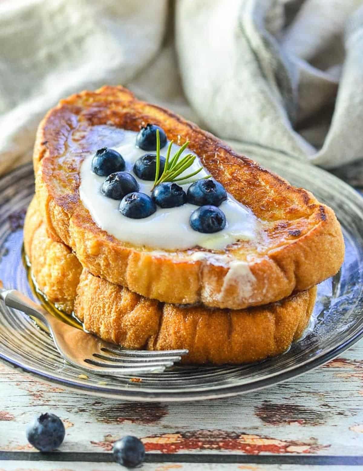 2 slices of vegan french toast with yogurt and blueberries